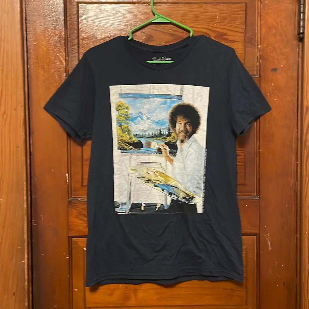 A dark navy blueish Bob Ross shirt with Bob Ross himself